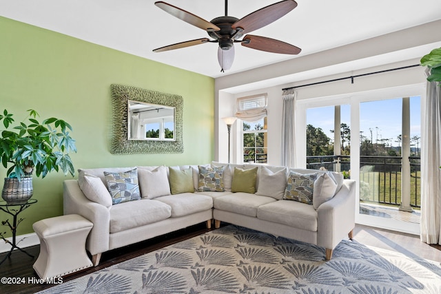 living room featuring ceiling fan and wood-type flooring