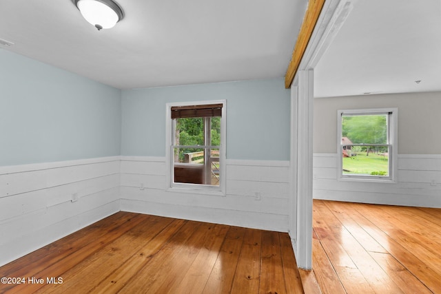 unfurnished room with hardwood / wood-style floors