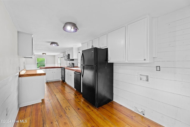 kitchen featuring black appliances, sink, light wood-type flooring, kitchen peninsula, and white cabinetry