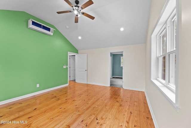 unfurnished bedroom featuring ceiling fan, light wood-type flooring, and vaulted ceiling