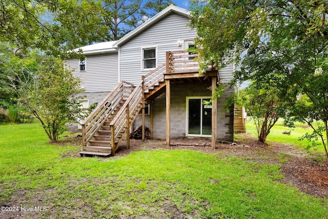 back of house featuring a yard and a deck