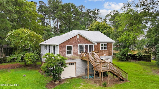 back of property with a yard and a garage