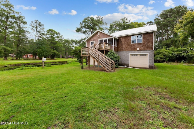 view of yard with a wooden deck and a garage