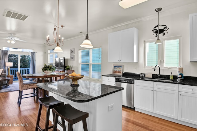 kitchen with ceiling fan with notable chandelier, sink, decorative light fixtures, dishwasher, and white cabinetry