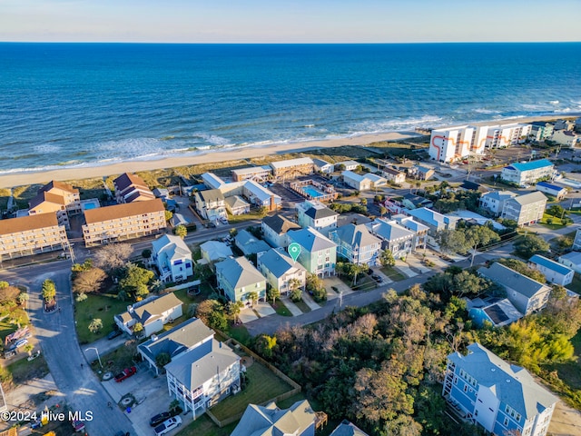 birds eye view of property with a water view and a view of the beach