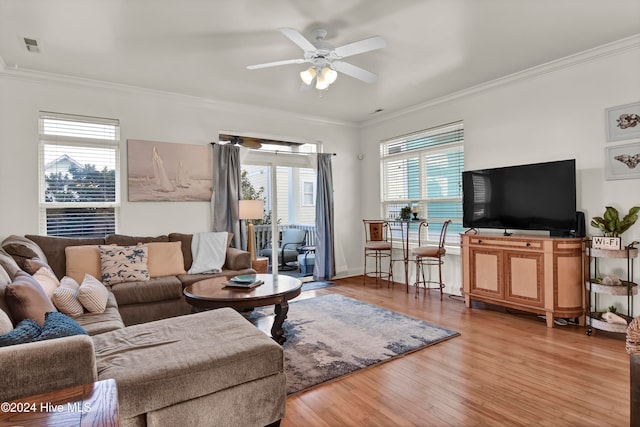 living room with ceiling fan, light hardwood / wood-style floors, and crown molding