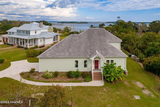 view of front of home featuring a front yard and a water view