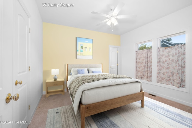 carpeted bedroom with ceiling fan