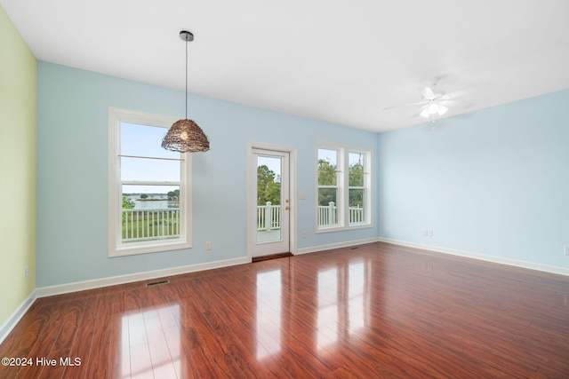 unfurnished room featuring ceiling fan and dark hardwood / wood-style flooring