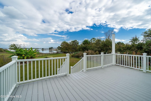 deck featuring a water view and a lawn