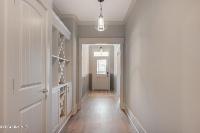 entryway featuring hardwood / wood-style flooring and ornamental molding