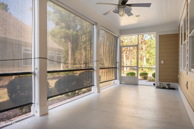 unfurnished sunroom featuring ceiling fan