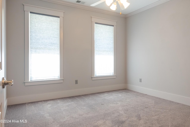 unfurnished room with ceiling fan, ornamental molding, and light colored carpet