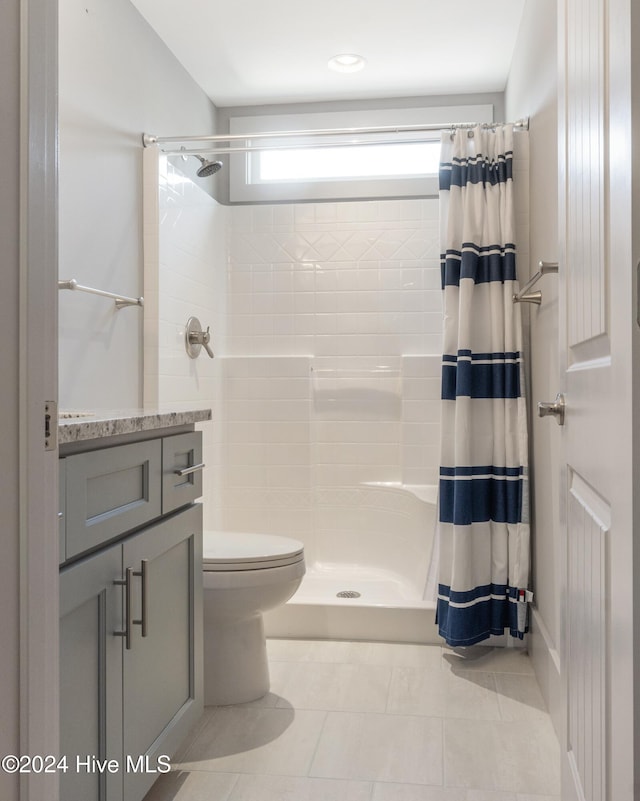 bathroom with vanity, a shower with shower curtain, toilet, and tile patterned flooring