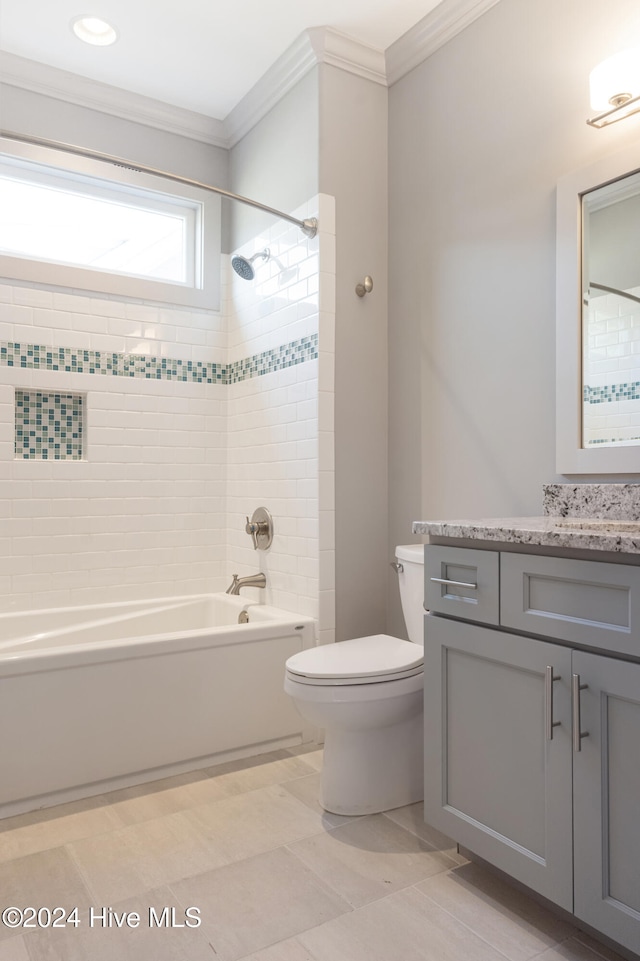 full bathroom featuring vanity, toilet, ornamental molding, and tiled shower / bath