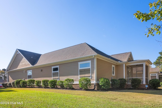 view of side of property with a yard