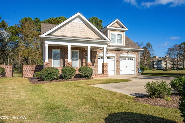 craftsman inspired home featuring a porch, a front lawn, and a garage