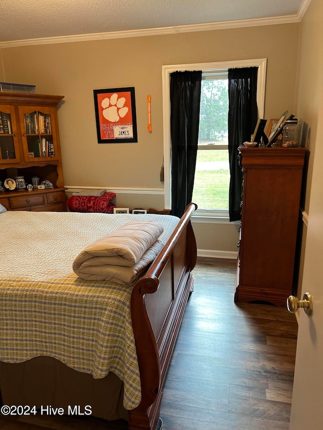 bedroom with ornamental molding and dark wood-type flooring