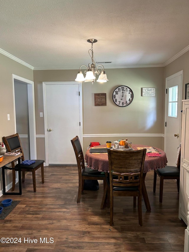 dining space with crown molding, a textured ceiling, dark hardwood / wood-style flooring, and a chandelier