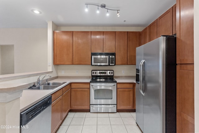 kitchen featuring sink, light tile patterned floors, and stainless steel appliances