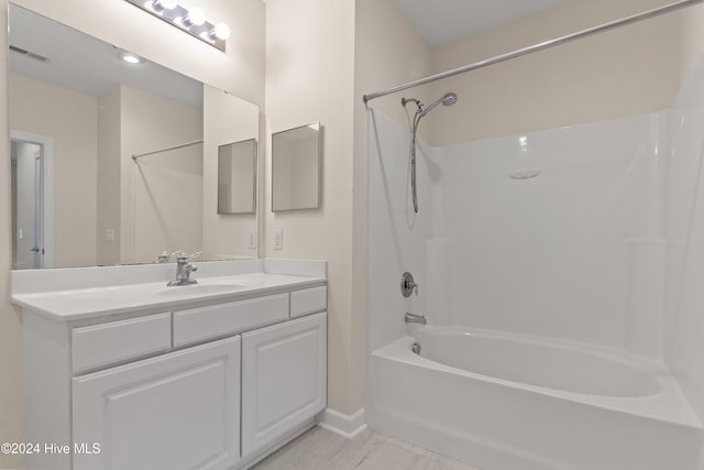 bathroom with vanity and washtub / shower combination