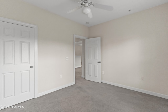 unfurnished bedroom with ceiling fan and light carpet