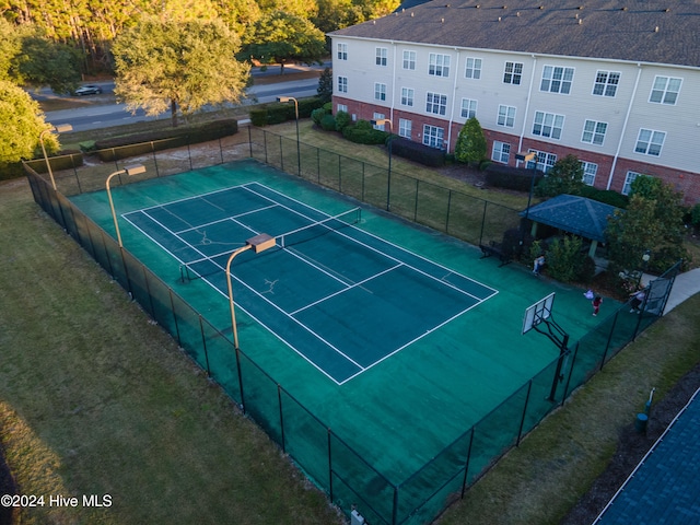 view of sport court featuring a yard