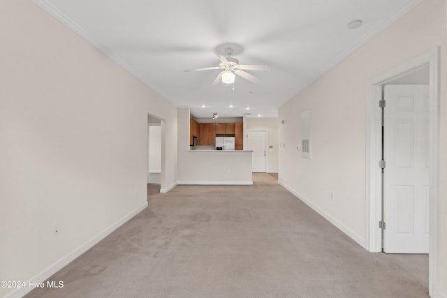 unfurnished living room with ceiling fan, light colored carpet, and ornamental molding