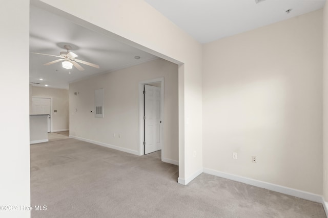 carpeted spare room featuring ceiling fan