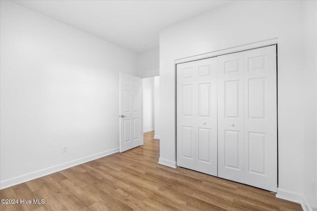 34 Bless Ave, Bolton, NC 28423 - unfurnished bedroom featuring light wood-style flooring, baseboards, and a closet