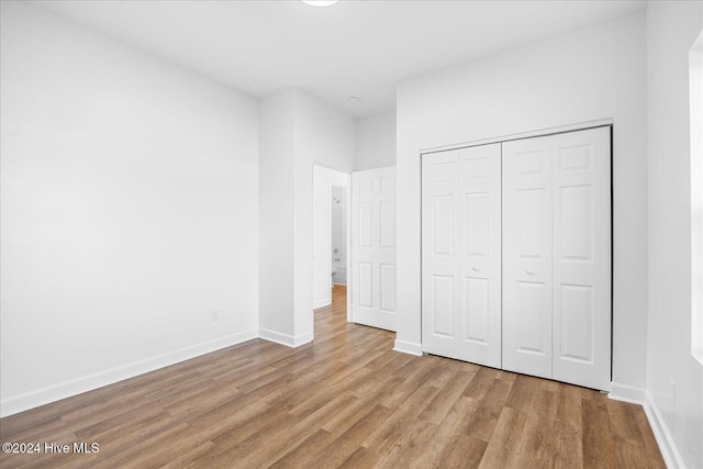 34 Bless Ave, Bolton, NC 28423 - unfurnished bedroom featuring wood finished floors, baseboards, and a closet