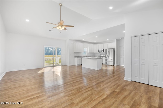 34 Bless Ave, Bolton, NC 28423 - unfurnished living room with ceiling fan, high vaulted ceiling, light wood-style floors, recessed lighting, and baseboards