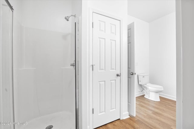 34 Bless Ave, Bolton, NC 28423 - full bath featuring a stall shower, toilet, wood finished floors, and baseboards