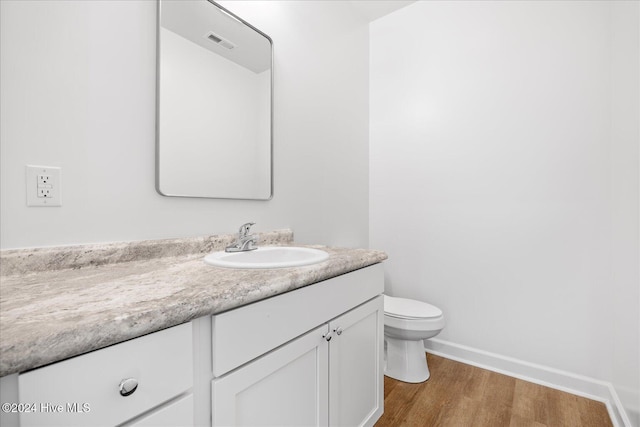 34 Bless Ave, Bolton, NC 28423 - bathroom featuring wood finished floors, baseboards, vanity, and toilet