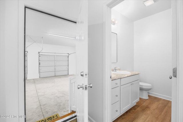 34 Bless Ave, Bolton, NC 28423 - bathroom with toilet, vanity, wood finished floors, and baseboards
