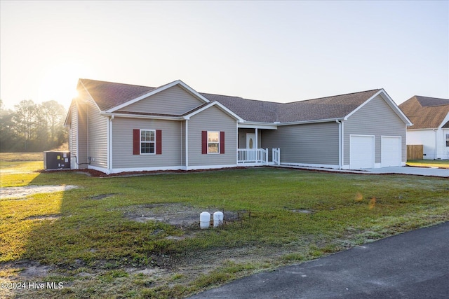 34 Bless Ave, Bolton, NC 28423 - ranch-style house with an attached garage, a front lawn, and central AC unit