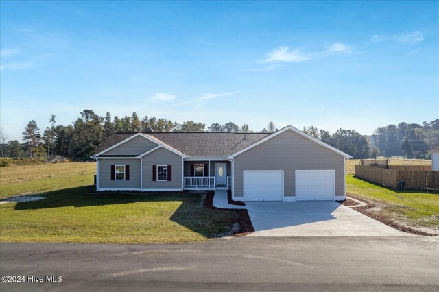 34 Bless Ave, Bolton, NC 28423 - ranch-style house with driveway, an attached garage, and a porch