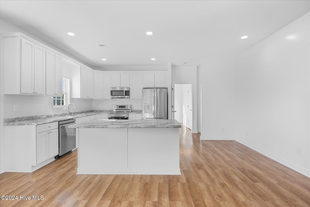 34 Bless Ave, Bolton, NC 28423 - kitchen with appliances with stainless steel finishes, white cabinets, light wood-type flooring, recessed lighting, and a kitchen island