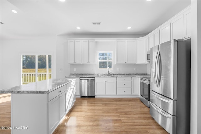 34 Bless Ave, Bolton, NC 28423 - kitchen featuring stainless steel appliances, recessed lighting, white cabinetry, light wood-style floors, and a sink
