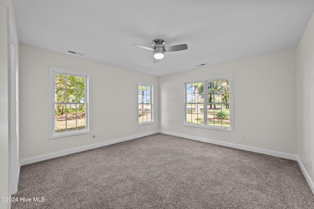 spare room featuring ceiling fan and carpet floors