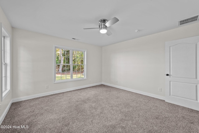 unfurnished room featuring ceiling fan and carpet