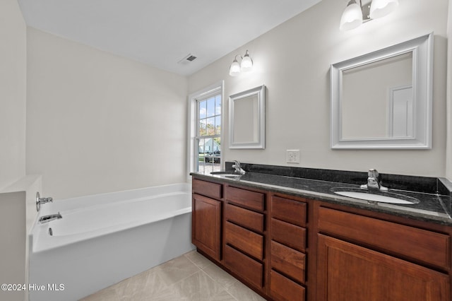 bathroom featuring vanity, a tub to relax in, and tile patterned floors