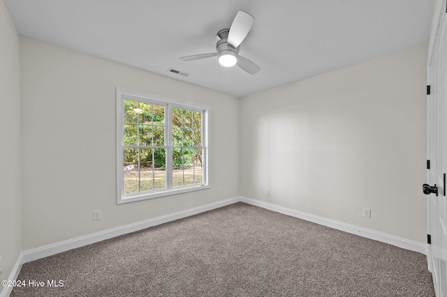 carpeted spare room featuring ceiling fan