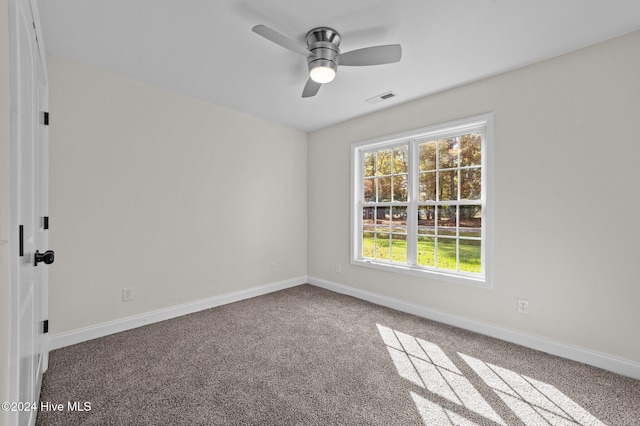 carpeted spare room with ceiling fan