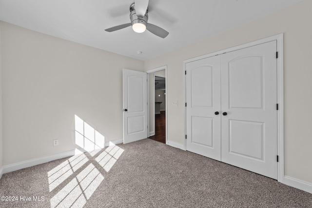 unfurnished bedroom featuring a closet, ceiling fan, and dark colored carpet