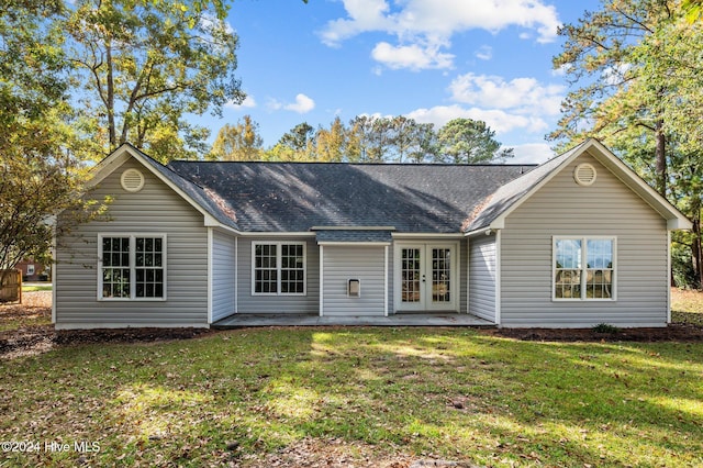 rear view of property featuring french doors and a yard