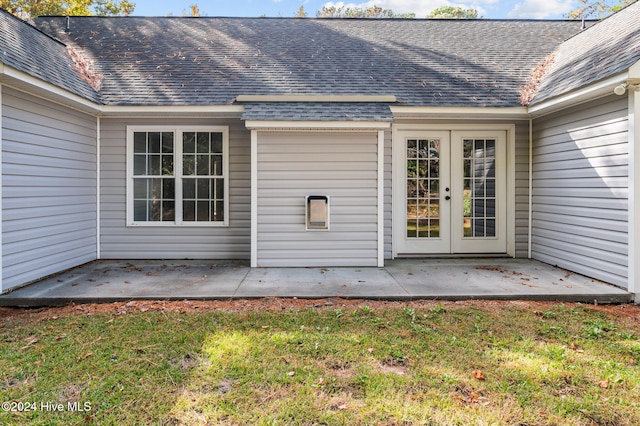 property entrance with french doors, a yard, and a patio