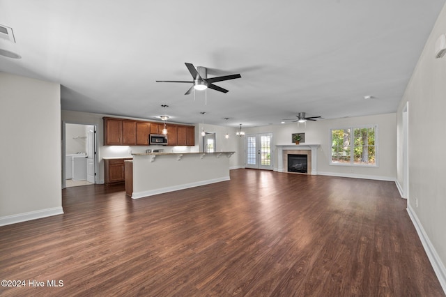 unfurnished living room with dark wood-type flooring and ceiling fan