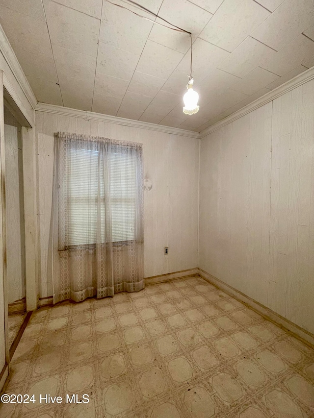 unfurnished room with crown molding