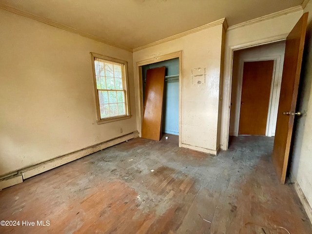 unfurnished bedroom featuring a closet, ornamental molding, baseboard heating, and dark hardwood / wood-style floors